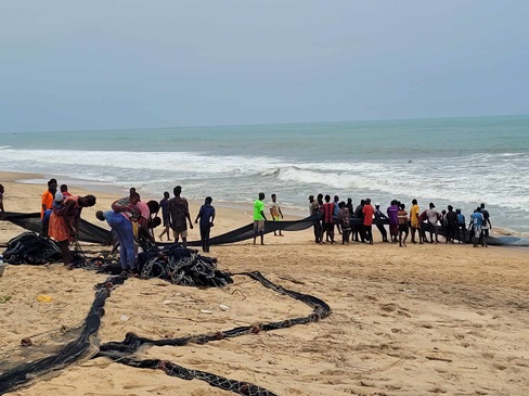 Fishermen hauling fishing nets, Ghana